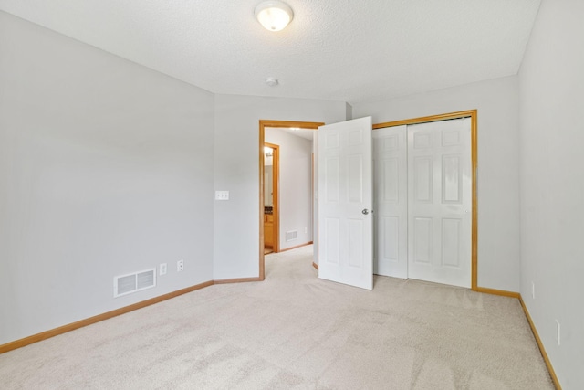 4107 Regent Ave N, Robbinsdale, MN 55422 - unfurnished bedroom featuring light colored carpet, baseboards, a textured ceiling, and a closet