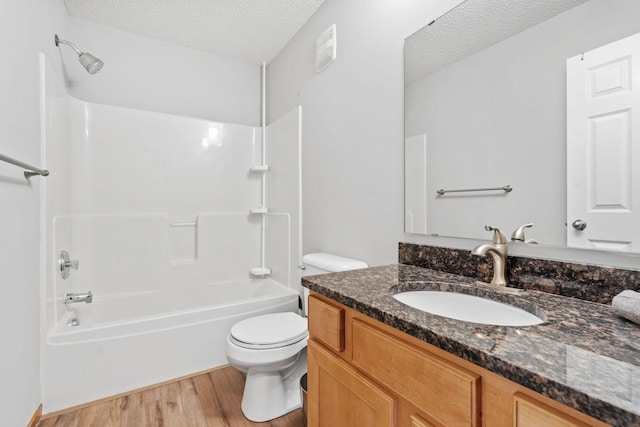 4107 Regent Ave N, Robbinsdale, MN 55422 - bathroom featuring wood finished floors, a textured ceiling, vanity, toilet, and tub / shower combination