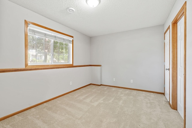 4107 Regent Ave N, Robbinsdale, MN 55422 - unfurnished bedroom with light colored carpet, a textured ceiling, and baseboards