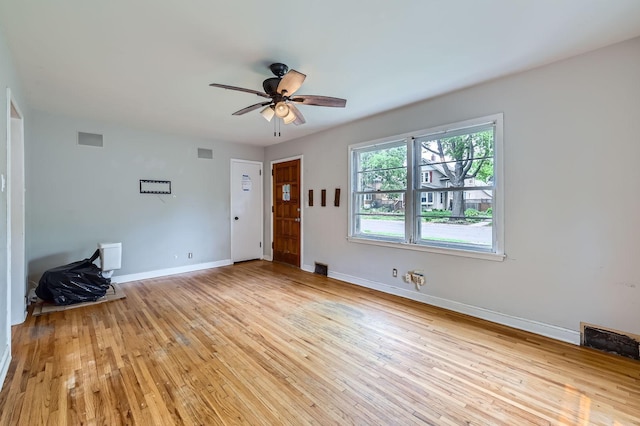 583 Cromwell Ave, Saint Paul, MN 55104 - unfurnished living room featuring a ceiling fan, light wood-style flooring, and baseboards