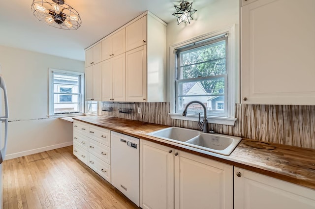 583 Cromwell Ave, Saint Paul, MN 55104 - kitchen with white dishwasher, a sink, plenty of natural light, and butcher block countertops