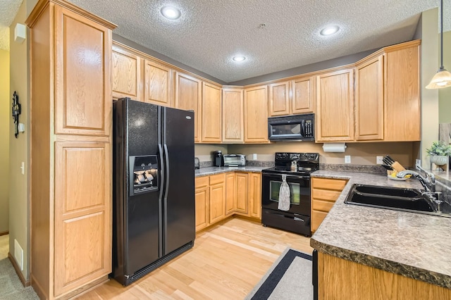 3661 Hazel Trl Unit H, Woodbury, MN 55129 - kitchen featuring black appliances, a sink, light brown cabinets, light wood-style floors, and a textured ceiling