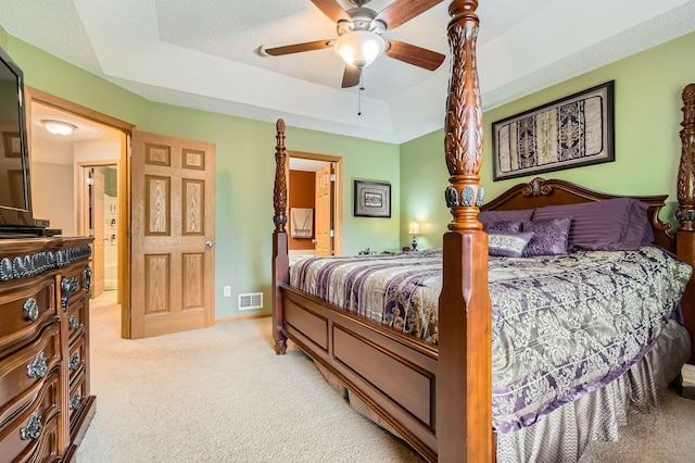 3661 Hazel Trl Unit H, Woodbury, MN 55129 - bedroom featuring light colored carpet, a tray ceiling, a ceiling fan, and connected bathroom