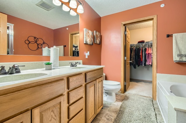 3661 Hazel Trl Unit H, Woodbury, MN 55129 - full bath with a textured ceiling, double vanity, toilet, a garden tub, and a spacious closet