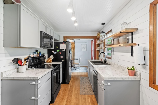 9301 Northwood Pkwy, New Hope, MN 55427 - kitchen featuring black appliances, gray cabinetry, light wood finished floors, light countertops, and open shelves