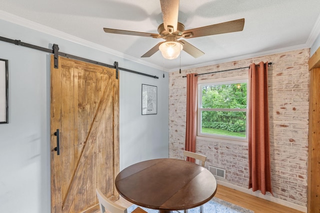 9301 Northwood Pkwy, New Hope, MN 55427 - sitting room featuring a barn door, brick wall, wood finished floors, ornamental molding, and a ceiling fan