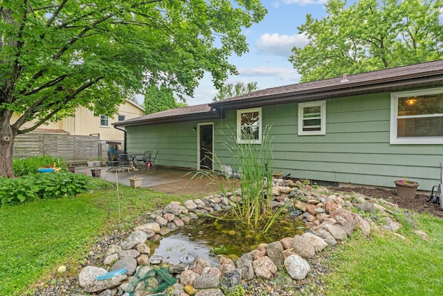 9301 Northwood Pkwy, New Hope, MN 55427 - rear view of house with a patio and a garden pond