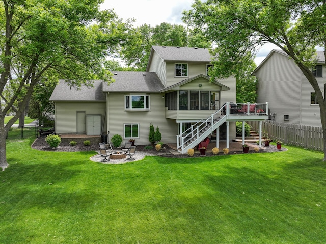 8821 Jonquil Ln N, Maple Grove, MN 55369 - back of house with a sunroom, a fire pit, stairway, a shingled roof, and a deck