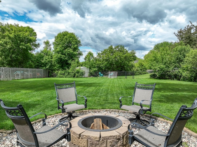 8821 Jonquil Ln N, Maple Grove, MN 55369 - view of patio / terrace with a fire pit and view of wooded area
