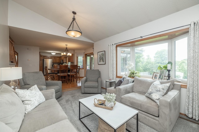 8821 Jonquil Ln N, Maple Grove, MN 55369 - living area featuring vaulted ceiling, a chandelier, and baseboards