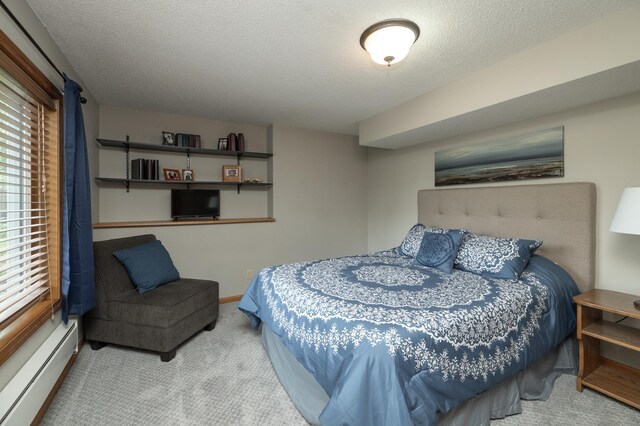 8821 Jonquil Ln N, Maple Grove, MN 55369 - carpeted bedroom featuring a baseboard heating unit and a textured ceiling