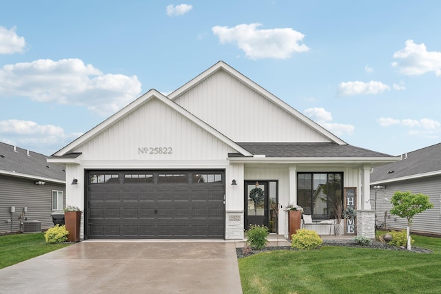 25822 Emerson Ct, Wyoming, MN 55092 - view of front facade with a porch, an attached garage, a front lawn, driveway, and board and batten siding