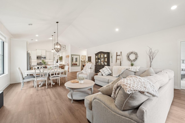 25822 Emerson Ct, Wyoming, MN 55092 - living room featuring lofted ceiling, light wood-style floors, a chandelier, recessed lighting, and baseboards