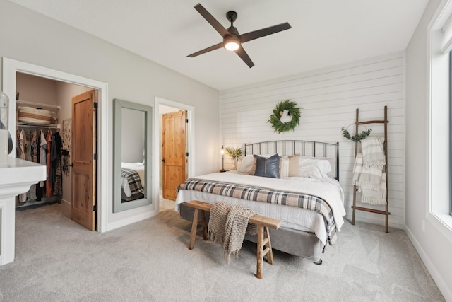 25822 Emerson Ct, Wyoming, MN 55092 - carpeted bedroom with a walk in closet, ceiling fan, and wood walls