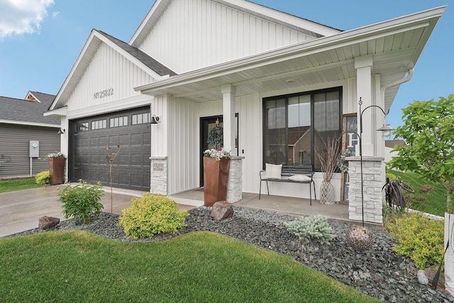 25822 Emerson Ct, Wyoming, MN 55092 - view of front facade featuring covered porch, a garage, driveway, and board and batten siding