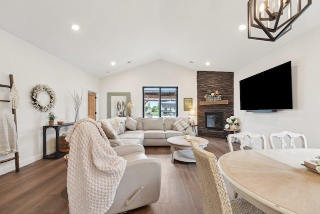 25822 Emerson Ct, Wyoming, MN 55092 - living area featuring vaulted ceiling, dark wood-type flooring, a stone fireplace, recessed lighting, and a chandelier