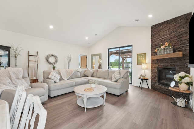 25822 Emerson Ct, Wyoming, MN 55092 - living room featuring wood finished floors, a fireplace, high vaulted ceiling, and recessed lighting