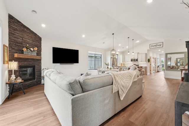 25822 Emerson Ct, Wyoming, MN 55092 - living room featuring light wood-type flooring, a fireplace, recessed lighting, and high vaulted ceiling
