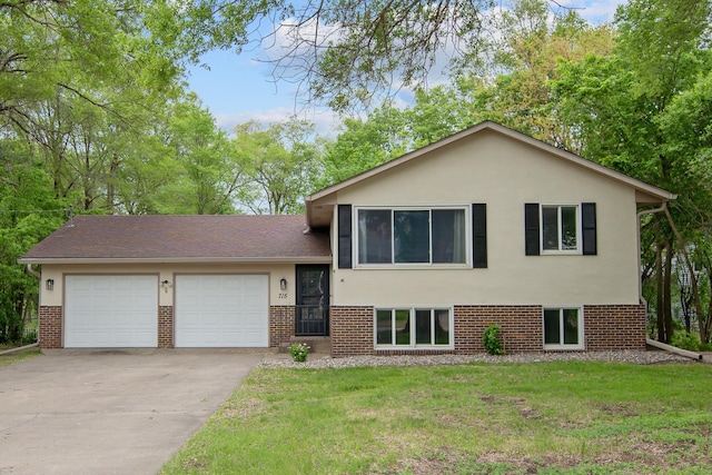 715 3rd St, Monticello, MN 55362 - tri-level home featuring an attached garage, driveway, brick siding, and a front yard