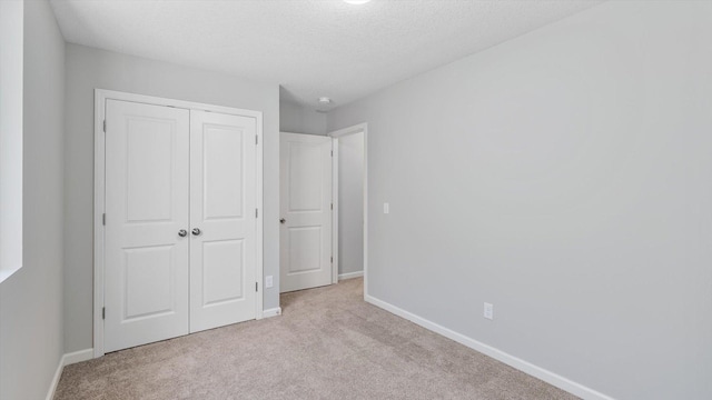 6455 Timber Arch Dr, Chaska, MN 55318 - unfurnished bedroom with light colored carpet, a closet, baseboards, and a textured ceiling