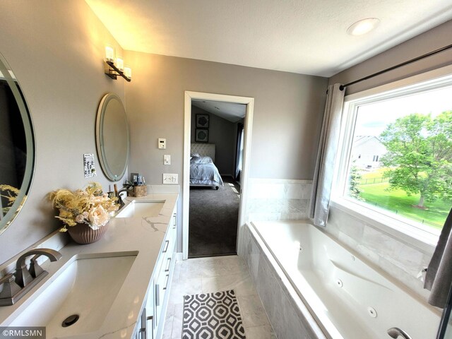 10402 Indiana Ave N, Brooklyn Park, MN 55443 - ensuite bathroom featuring double vanity, a whirlpool tub, and tile patterned floors