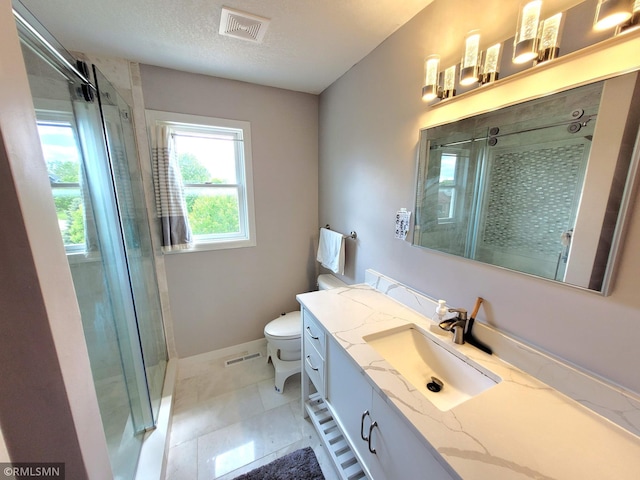 10402 Indiana Ave N, Brooklyn Park, MN 55443 - bathroom featuring toilet, vanity, a stall shower, and baseboards