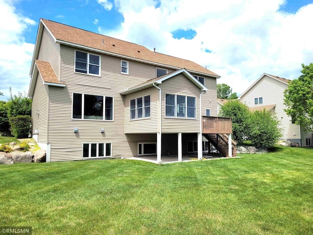 10402 Indiana Ave N, Brooklyn Park, MN 55443 - rear view of house with stairs, a patio, a deck, a yard, and a shingled roof