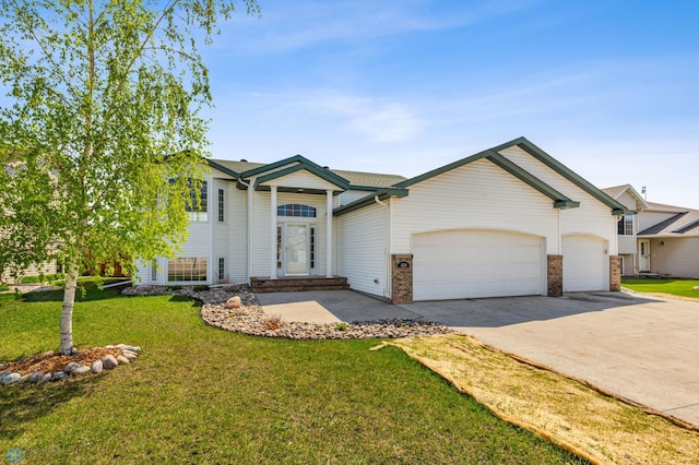 1586 Baywood Dr, Fargo, ND 58078 - view of front of home featuring a garage, concrete driveway, and a front lawn