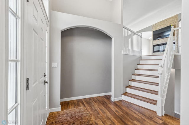 1586 Baywood Dr, Fargo, ND 58078 - foyer entrance featuring arched walkways, wood finished floors, baseboards, and stairway
