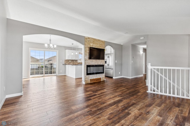 1586 Baywood Dr, Fargo, ND 58078 - unfurnished living room with lofted ceiling, dark wood-style flooring, baseboards, and a chandelier