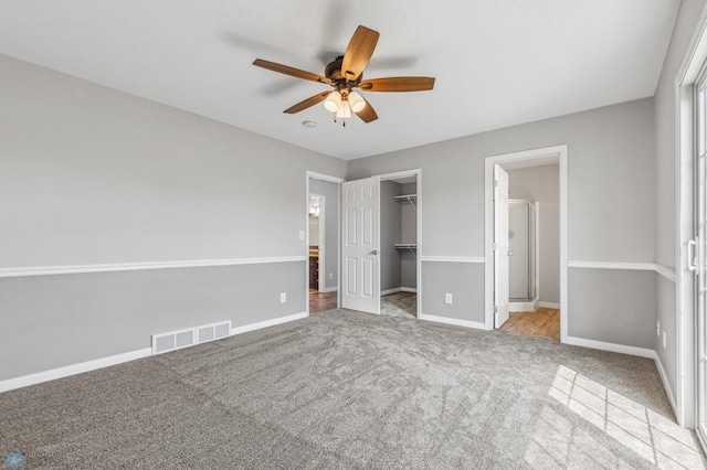 1586 Baywood Dr, Fargo, ND 58078 - unfurnished bedroom featuring carpet, baseboards, a closet, ceiling fan, and a spacious closet