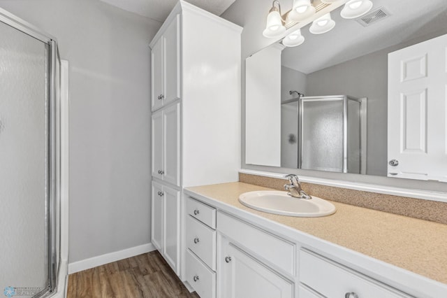 1586 Baywood Dr, Fargo, ND 58078 - full bath featuring a stall shower, vanity, wood finished floors, and baseboards