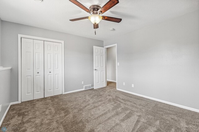 1586 Baywood Dr, Fargo, ND 58078 - unfurnished bedroom featuring carpet, a closet, baseboards, and a ceiling fan