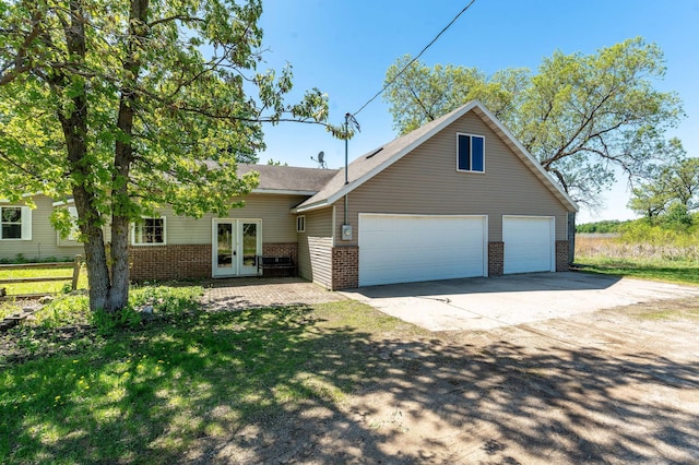45379 Crystal Hills Dr, Lida Twp, MN 56572 - traditional home featuring french doors, brick siding, a garage, and driveway