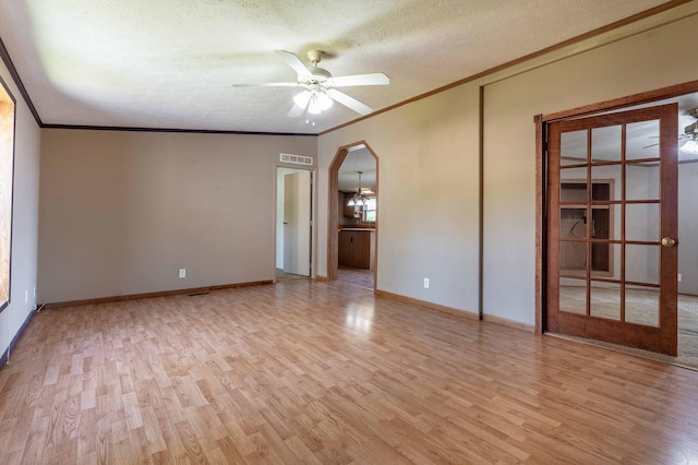 45379 Crystal Hills Dr, Lida Twp, MN 56572 - empty room with ornamental molding, a textured ceiling, light wood-style floors, a ceiling fan, and arched walkways