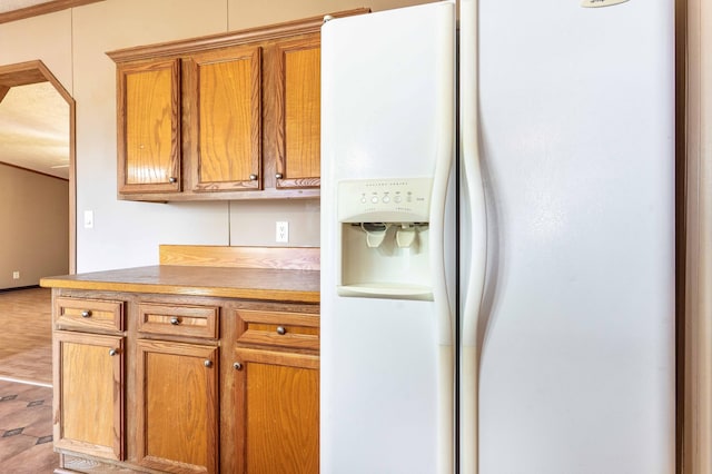 45379 Crystal Hills Dr, Lida Twp, MN 56572 - kitchen with white fridge with ice dispenser, brown cabinets, and light countertops