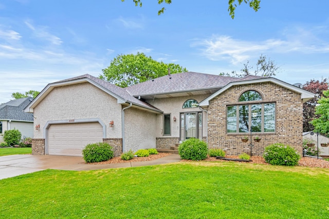 4985 142nd Ln NW, Ramsey, MN 55303 - view of front of property featuring brick siding, a garage, driveway, and a front yard