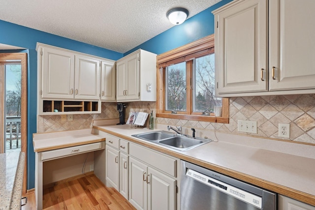 4985 142nd Ln NW, Ramsey, MN 55303 - kitchen featuring dishwasher, light countertops, light wood-style flooring, a textured ceiling, and backsplash