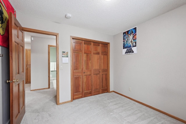 4985 142nd Ln NW, Ramsey, MN 55303 - unfurnished bedroom featuring light colored carpet, a closet, and a textured ceiling