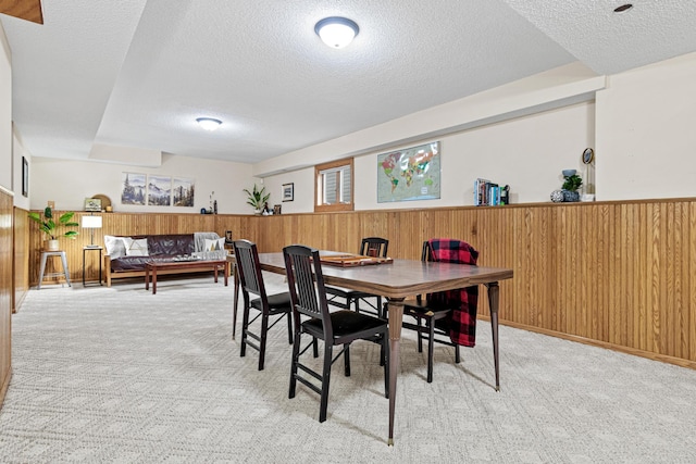 4985 142nd Ln NW, Ramsey, MN 55303 - dining room featuring a textured ceiling, light colored carpet, wood walls, and wainscoting
