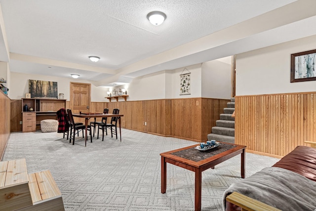 4985 142nd Ln NW, Ramsey, MN 55303 - living room with a wainscoted wall, a textured ceiling, stairway, wooden walls, and light colored carpet