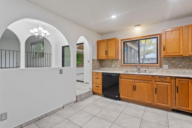 2908 81st Ave N, Brooklyn Park, MN 55444 - kitchen with black dishwasher, a sink, light countertops, tasteful backsplash, and a textured ceiling