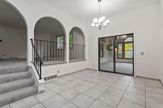 2908 81st Ave N, Brooklyn Park, MN 55444 - spare room featuring a chandelier, light tile patterned floors, and stairway