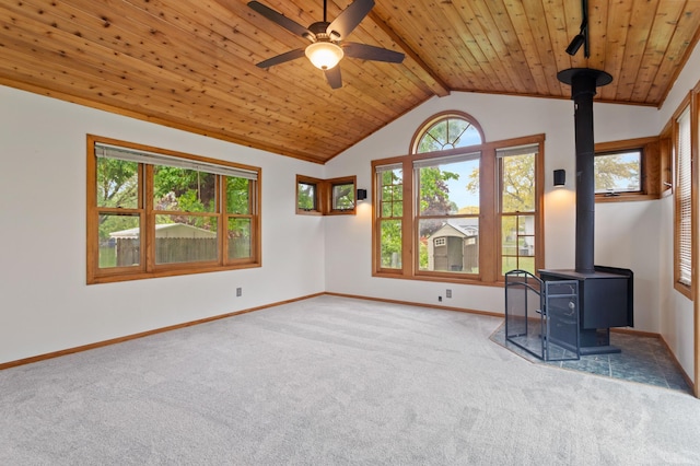 2908 81st Ave N, Brooklyn Park, MN 55444 - unfurnished room featuring a wood stove, carpet, wooden ceiling, baseboards, and a ceiling fan
