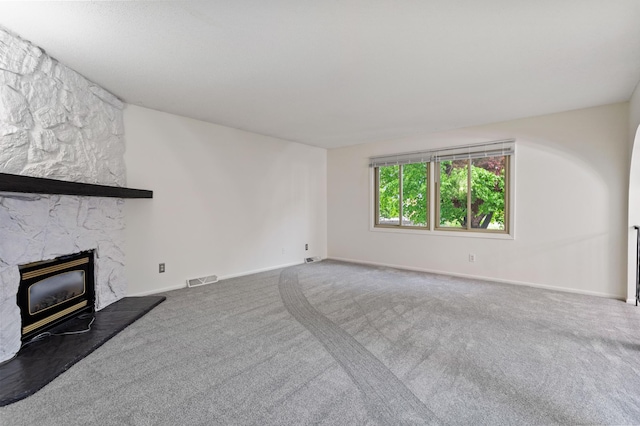 2908 81st Ave N, Brooklyn Park, MN 55444 - unfurnished living room featuring carpet floors, baseboards, and a fireplace