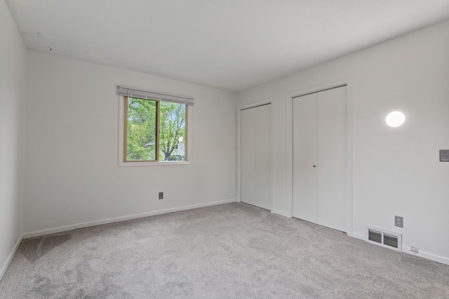 2908 81st Ave N, Brooklyn Park, MN 55444 - unfurnished bedroom featuring two closets, carpet, and baseboards