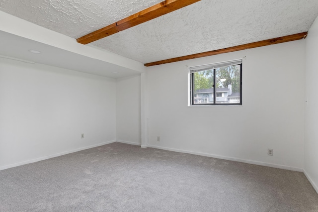 2908 81st Ave N, Brooklyn Park, MN 55444 - empty room featuring carpet, a textured ceiling, beam ceiling, and baseboards