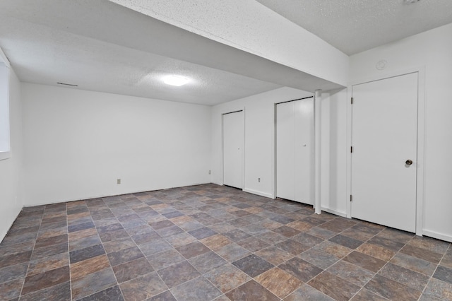 2908 81st Ave N, Brooklyn Park, MN 55444 - finished below grade area with stone finish flooring and a textured ceiling