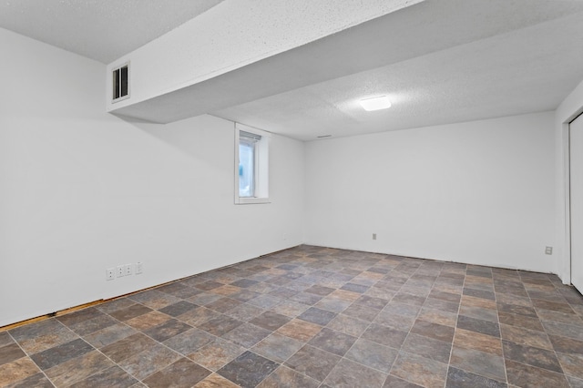 2908 81st Ave N, Brooklyn Park, MN 55444 - basement with stone finish flooring and a textured ceiling