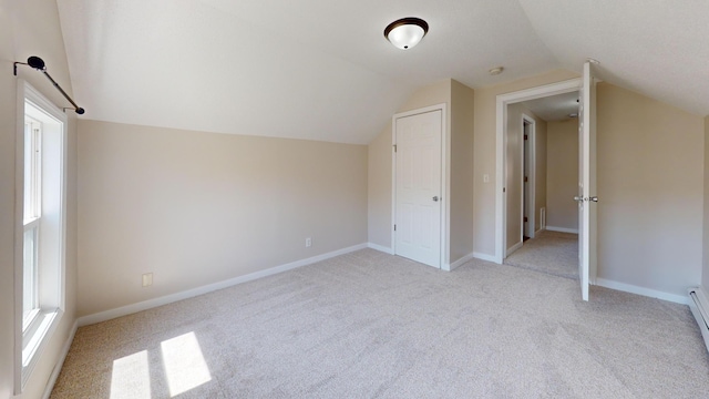 594 Charles Ave, Saint Paul, MN 55103 - additional living space with light carpet, lofted ceiling, and baseboards